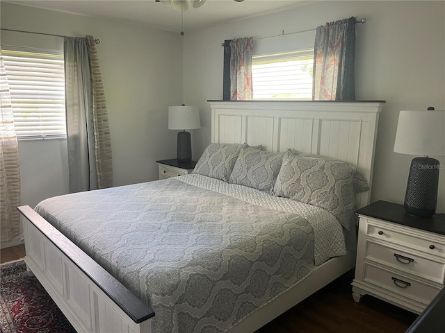 bedroom with dark hardwood / wood-style floors