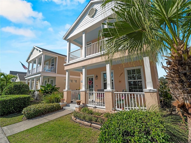 view of front of property featuring a balcony and a porch