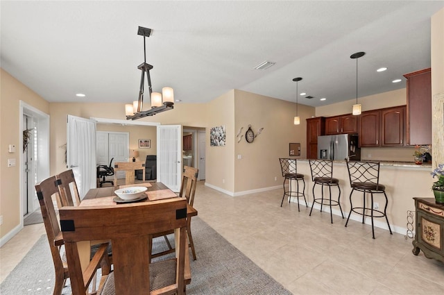 dining area with an inviting chandelier