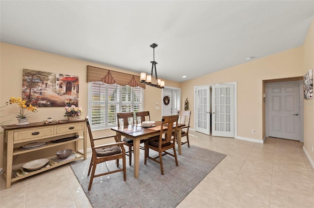 dining room featuring an inviting chandelier, light tile patterned floors, vaulted ceiling, and french doors