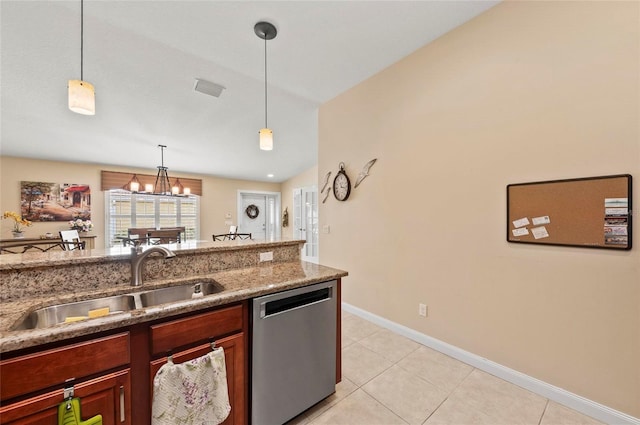 kitchen with light tile patterned flooring, sink, dark stone countertops, dishwasher, and pendant lighting