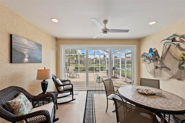 sunroom featuring ceiling fan