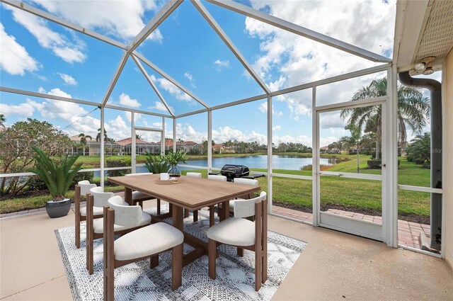 unfurnished sunroom featuring a water view