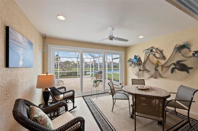 interior space featuring ceiling fan and a textured ceiling