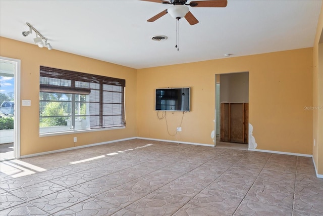 unfurnished room with ceiling fan and rail lighting