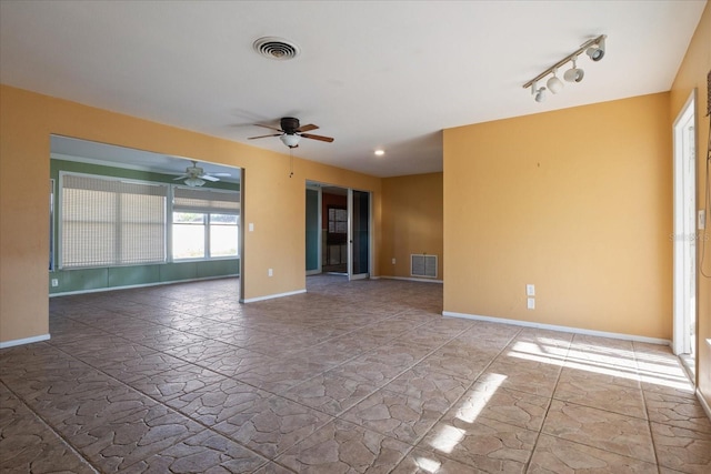 spare room featuring ceiling fan and rail lighting