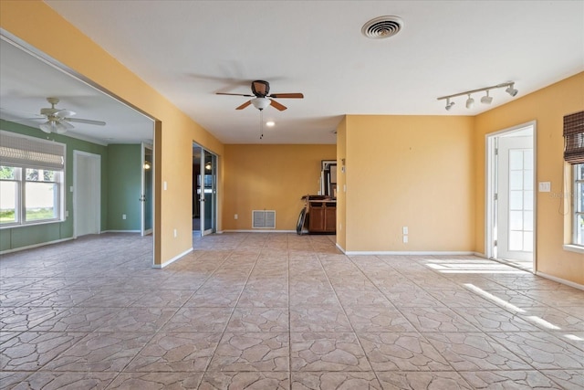 spare room with track lighting and ceiling fan