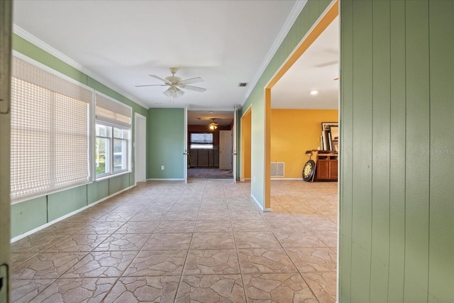 empty room featuring ornamental molding and ceiling fan