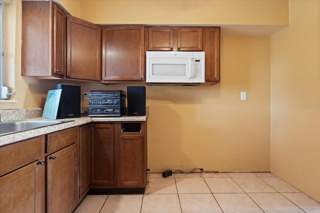 kitchen featuring sink and light tile patterned floors