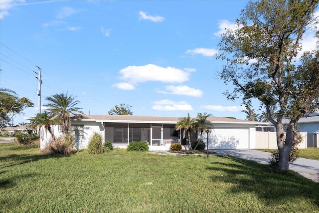 ranch-style home with a garage, a sunroom, and a front lawn