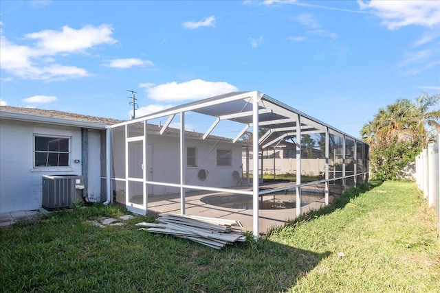 exterior space with a patio, a lanai, central AC, and a lawn