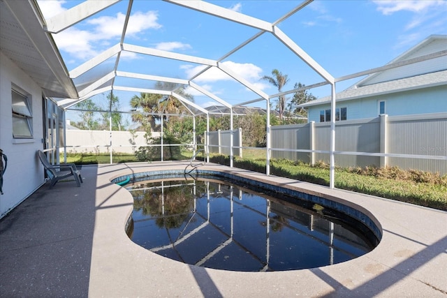 view of swimming pool featuring a patio and a lanai