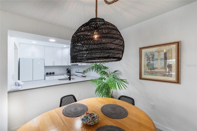 dining room featuring a textured ceiling