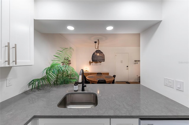 kitchen with white cabinetry, pendant lighting, a sink, and recessed lighting