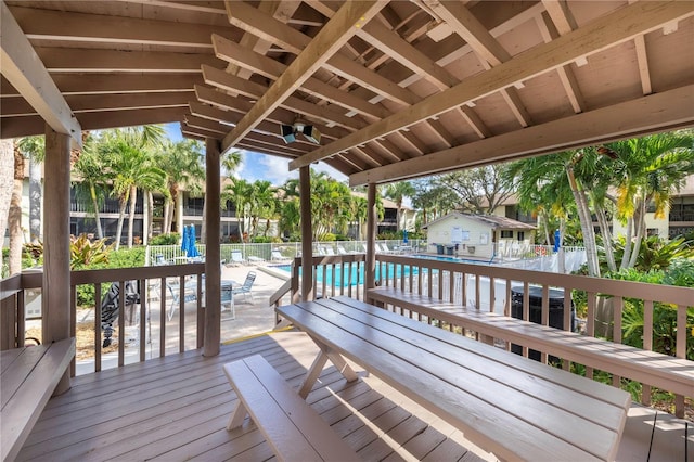 wooden terrace featuring fence and a community pool