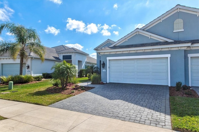 view of front facade with a garage and a front lawn