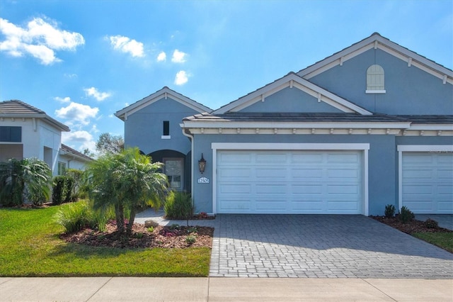 view of front of house featuring a garage and a front lawn