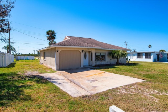 view of front of property with a garage and a front lawn