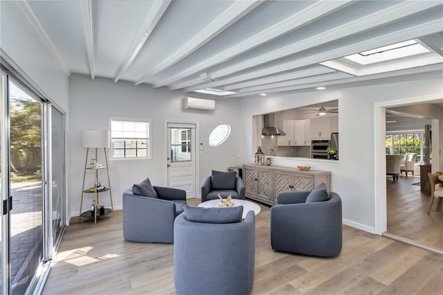 living area with a wealth of natural light, beam ceiling, light wood finished floors, and an AC wall unit