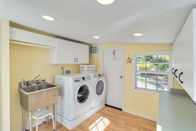 clothes washing area with recessed lighting, independent washer and dryer, cabinet space, and light wood-style floors