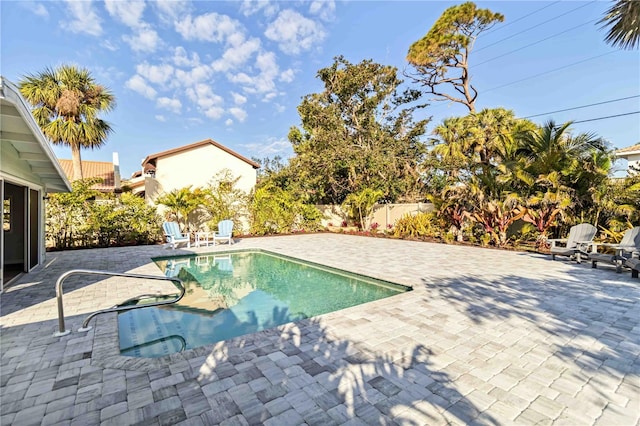 view of swimming pool featuring a patio area, fence, and a fenced in pool