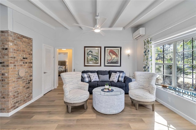 living area featuring a wall unit AC, baseboards, beam ceiling, and wood finished floors