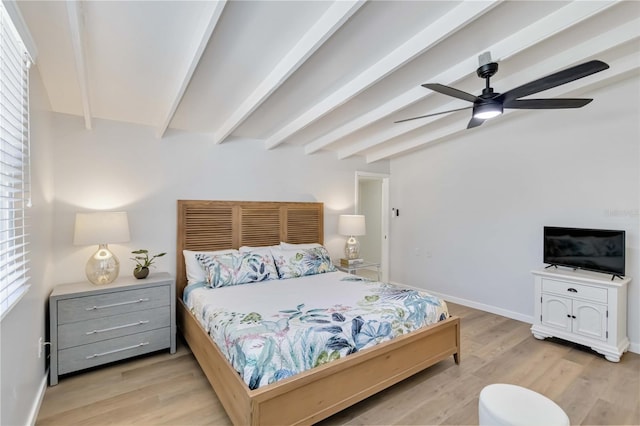 bedroom with light wood-type flooring, a ceiling fan, baseboards, and beam ceiling