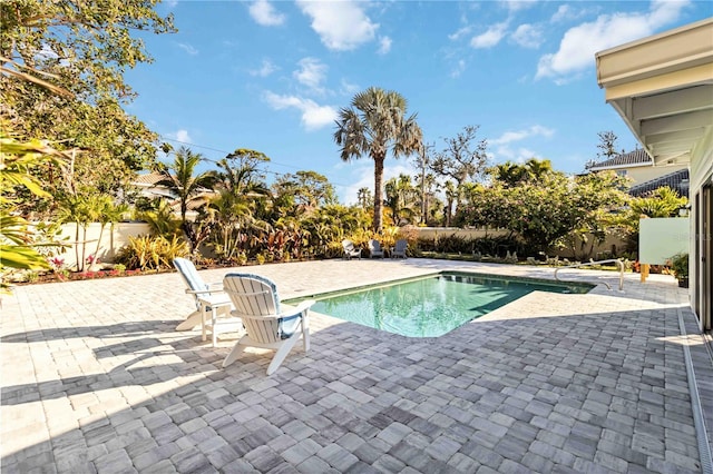 view of swimming pool with fence, a fenced in pool, and a patio