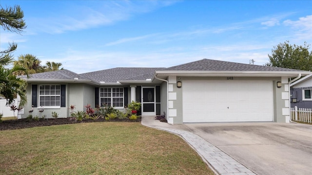 single story home featuring a garage and a front yard