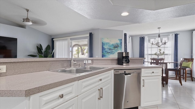 kitchen featuring white cabinetry, dishwasher, sink, and a wealth of natural light