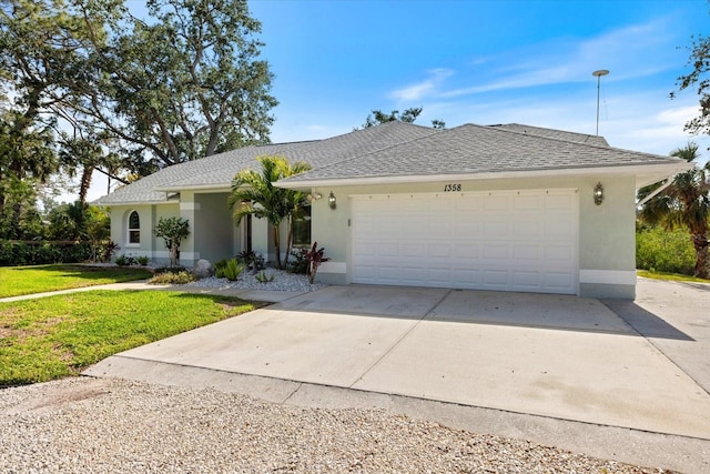 single story home with a garage and a front lawn