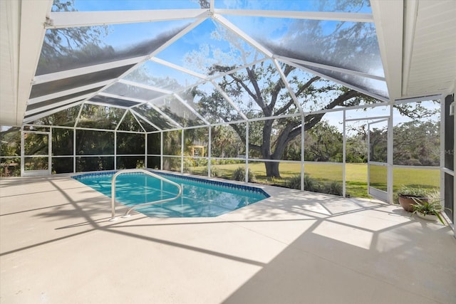 outdoor pool featuring a patio area and glass enclosure