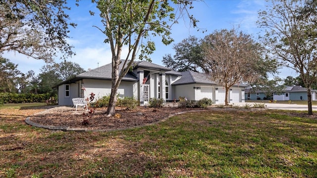 2537 Northway Dr, Venice, FL 34292 - view of front of property featuring an attached garage, driveway, a front lawn, and stucco siding