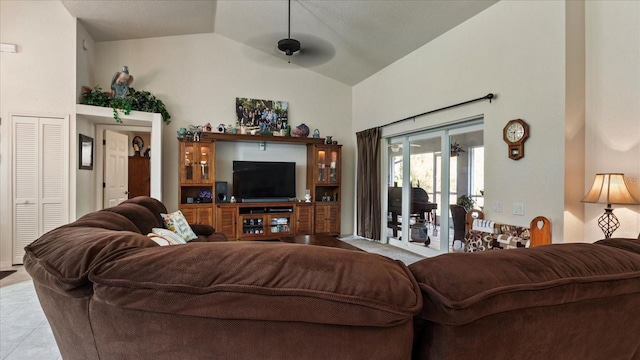 living room featuring ceiling fan, high vaulted ceiling, and light tile patterned floors