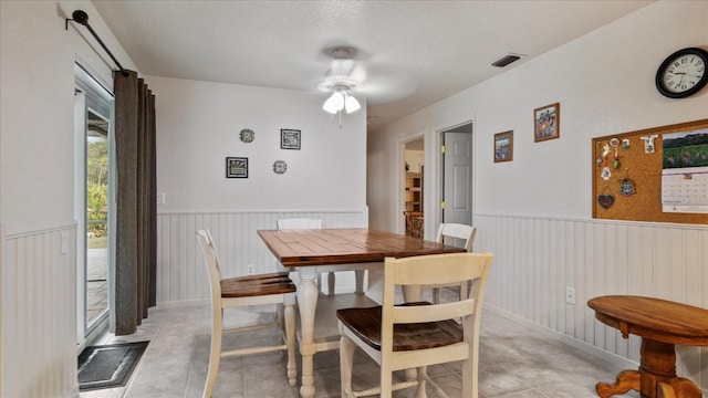 dining area with a textured ceiling and ceiling fan