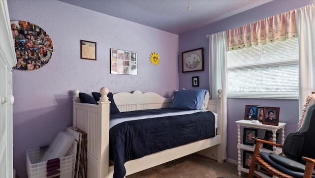 carpeted bedroom with a textured ceiling