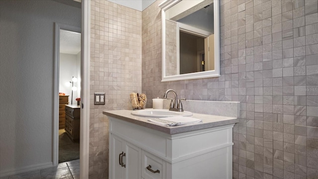 bathroom featuring tile walls and vanity