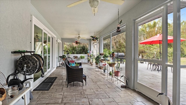 sunroom featuring ceiling fan