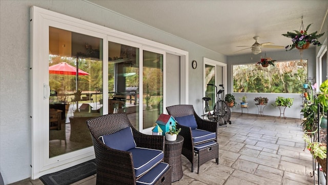 sunroom featuring ceiling fan