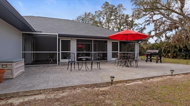 view of patio / terrace featuring a grill and a sunroom