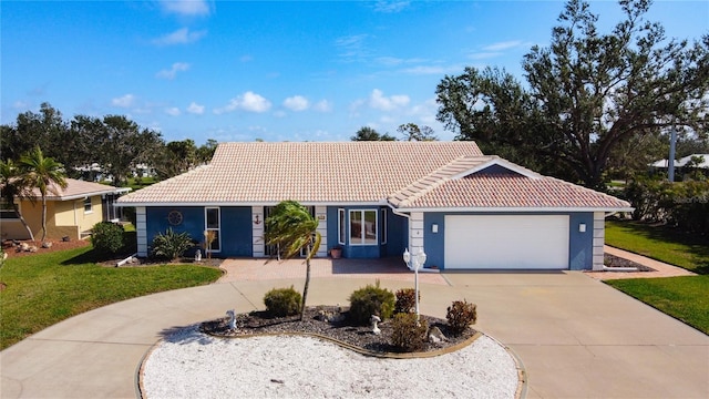 ranch-style home featuring a garage and a front lawn