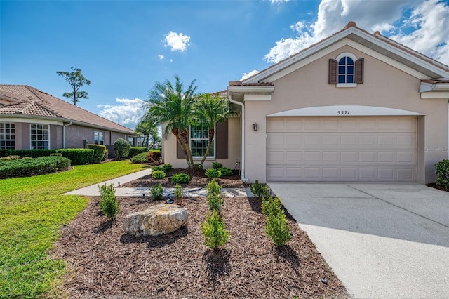 view of front of home with a garage and a front lawn