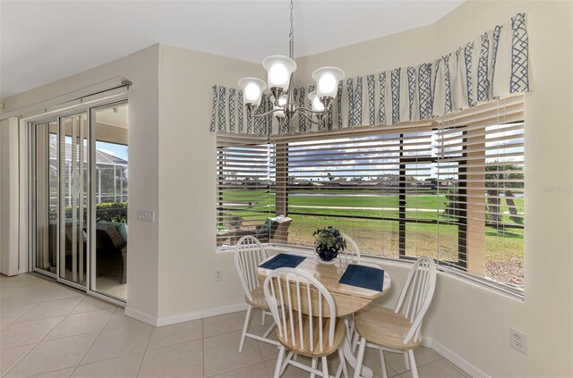 tiled dining space featuring a notable chandelier