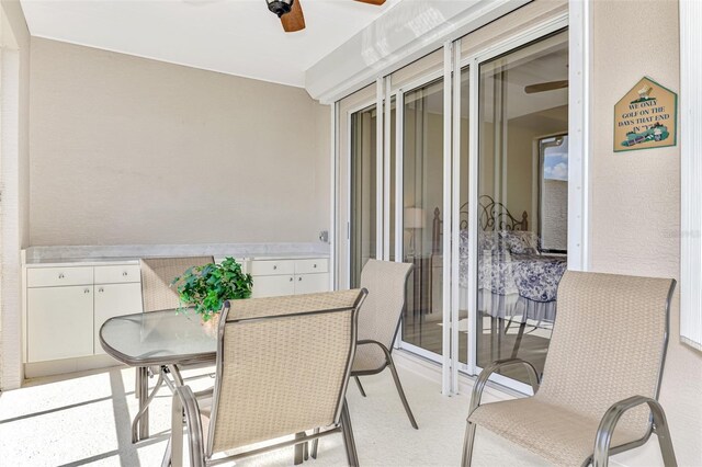 sunroom / solarium featuring ceiling fan