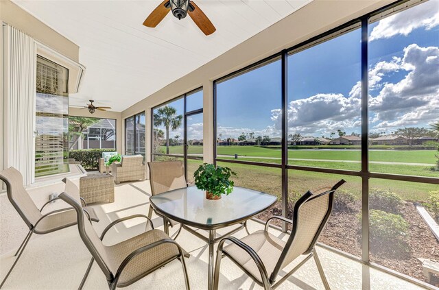 sunroom with a healthy amount of sunlight and ceiling fan