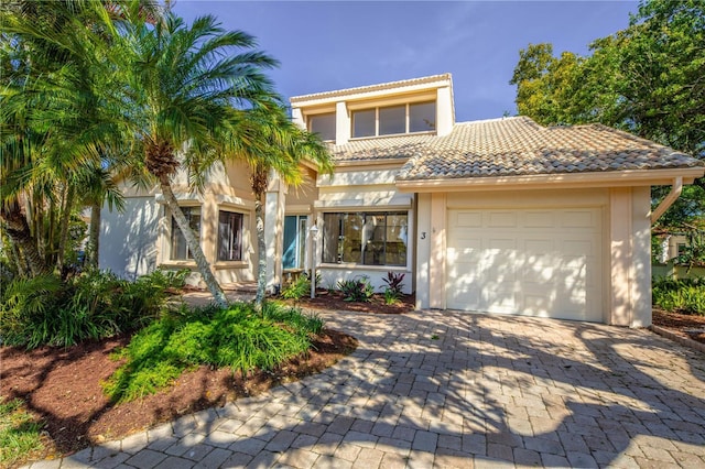 mediterranean / spanish-style home with a garage