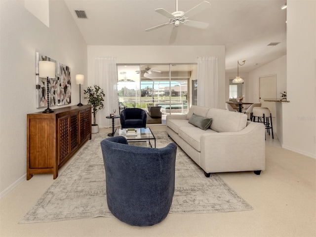 carpeted living room featuring vaulted ceiling and ceiling fan