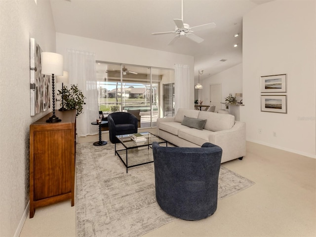 carpeted living room featuring ceiling fan and lofted ceiling