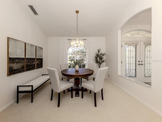 dining space with a notable chandelier and carpet floors