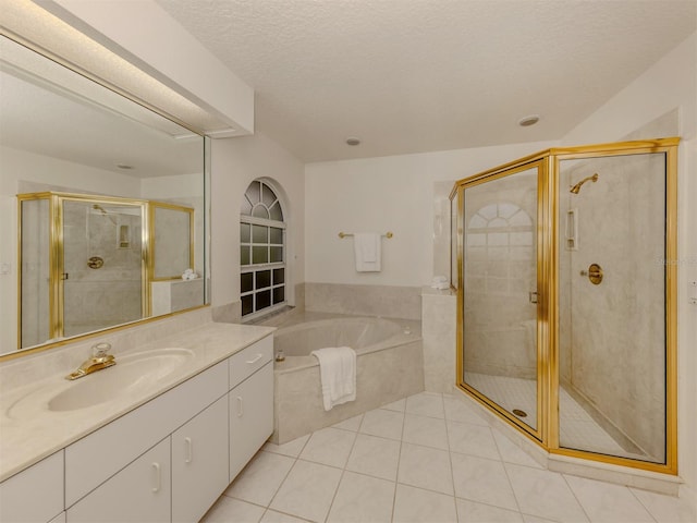 bathroom with vanity, tile patterned floors, independent shower and bath, and a textured ceiling